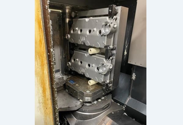 Okuma MA-40HA Twin Pallet Horizontal Machining Centre in a clean workshop environment, featuring a beige and blue body with a front viewing window and integrated control panel.