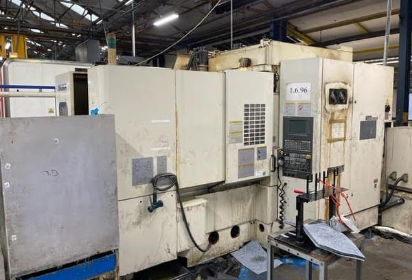 Okuma MA-40HA Twin Pallet Horizontal Machining Centre in a clean workshop environment, featuring a beige and blue body with a front viewing window and integrated control panel.