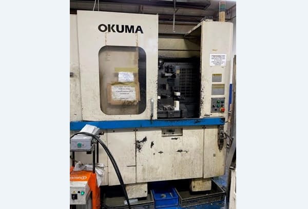 Okuma MA-40HA Twin Pallet Horizontal Machining Centre in a clean workshop environment, featuring a beige and blue body with a front viewing window and integrated control panel.