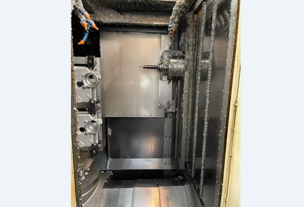 Okuma MA-40HA Twin Pallet Horizontal Machining Centre in a clean workshop environment, featuring a beige and blue body with a front viewing window and integrated control panel.