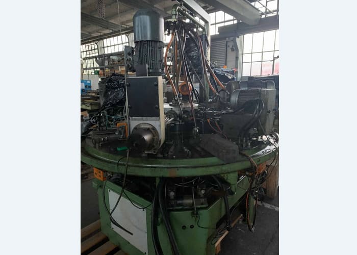 Win Win company’s RID 154G12 rotary transfer machine in an industrial facility, featuring multiple machining stations arranged in a circular configuration for automated, high-volume production processes