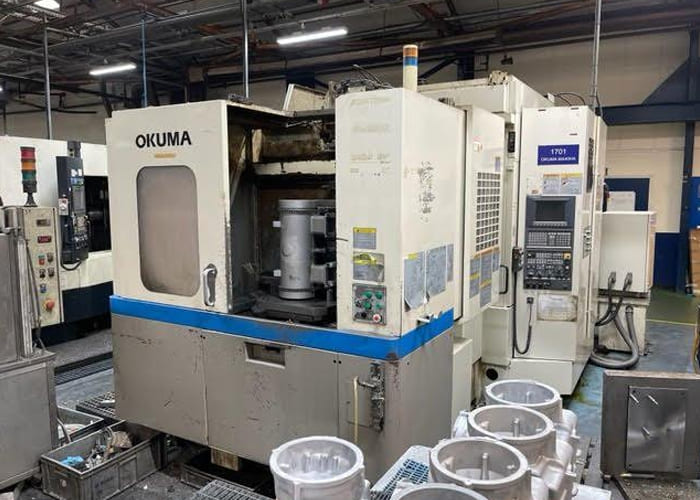 Okuma MA-40HA Twin Pallet Horizontal Machining Centre in a clean workshop environment, featuring a beige and blue body with a front viewing window and integrated control panel.