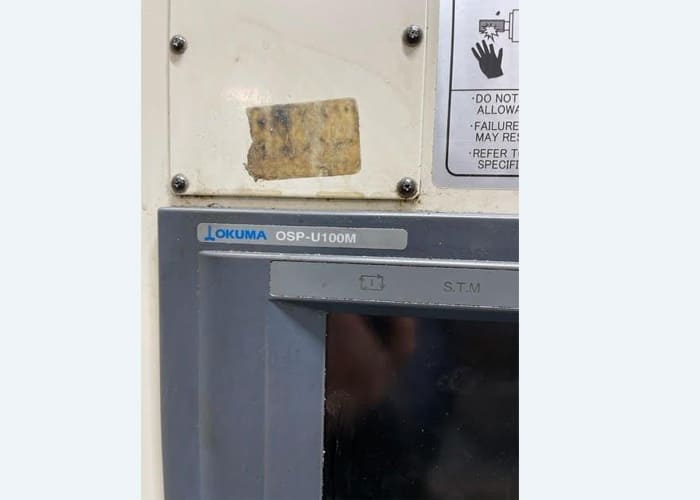 Okuma MA-40HA Twin Pallet Horizontal Machining Centre in a clean workshop environment, featuring a beige and blue body with a front viewing window and integrated control panel.