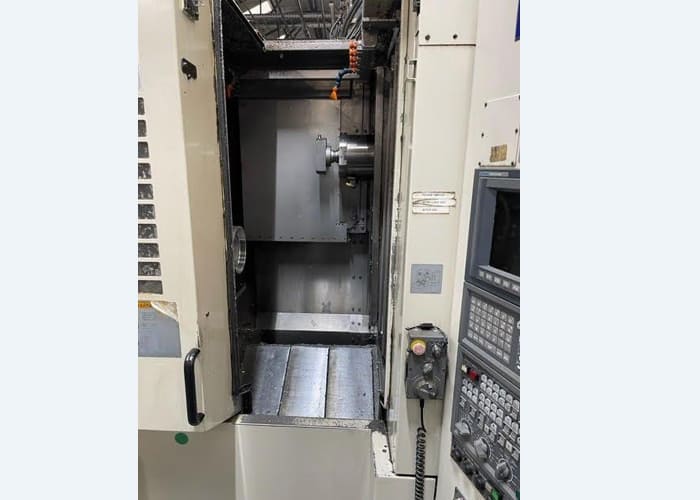 Okuma MA-40HA Twin Pallet Horizontal Machining Centre in a clean workshop environment, featuring a beige and blue body with a front viewing window and integrated control panel.