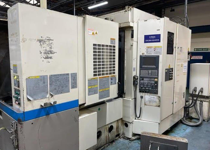 Okuma MA-40HA Twin Pallet Horizontal Machining Centre in a clean workshop environment, featuring a beige and blue body with a front viewing window and integrated control panel.