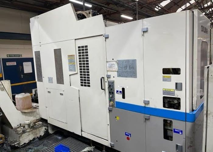 Okuma MA-40HA Twin Pallet Horizontal Machining Centre in a clean workshop environment, featuring a beige and blue body with a front viewing window and integrated control panel.